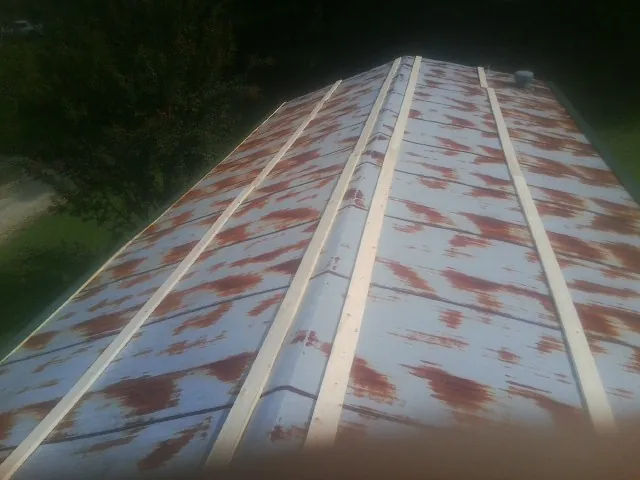 Rusted metal roof panels with new wood purlins before replacement — Storm Damage Roof Repair in Watchung by Roofing Brothers