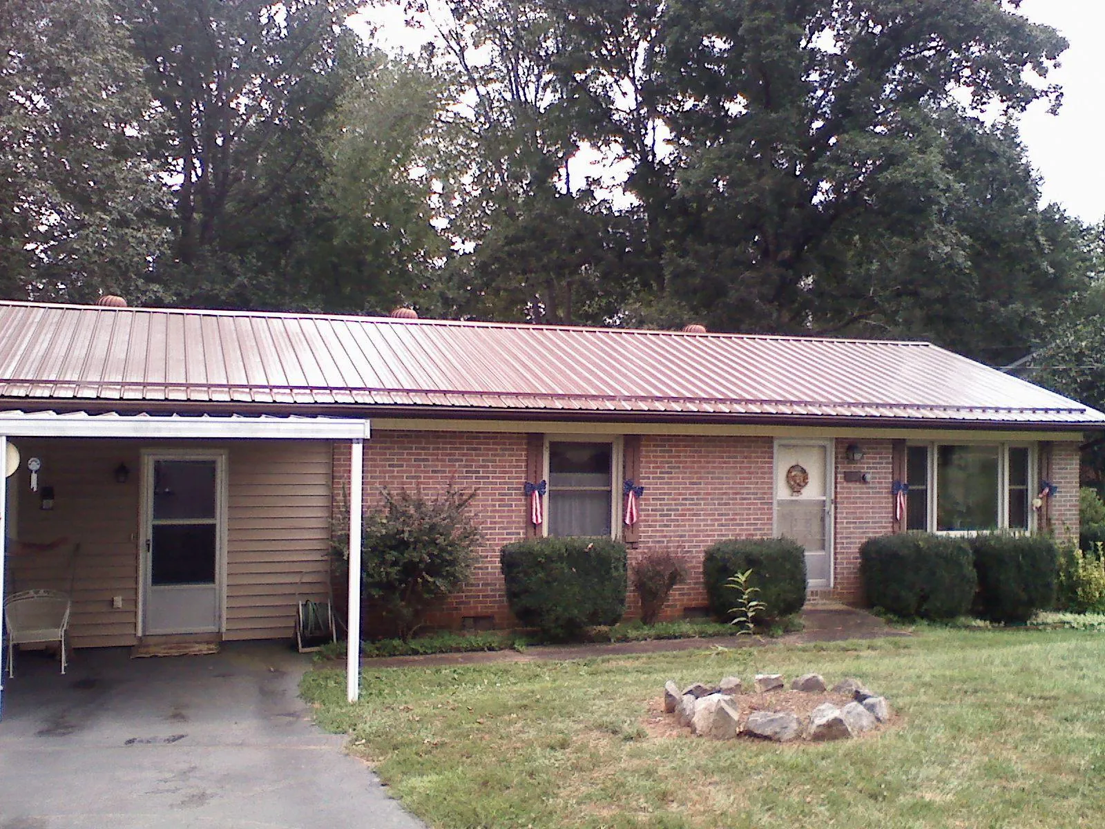 Bronze metal roof and carport on a brick ranch home — Roof Repair work by our crew in Watchung
