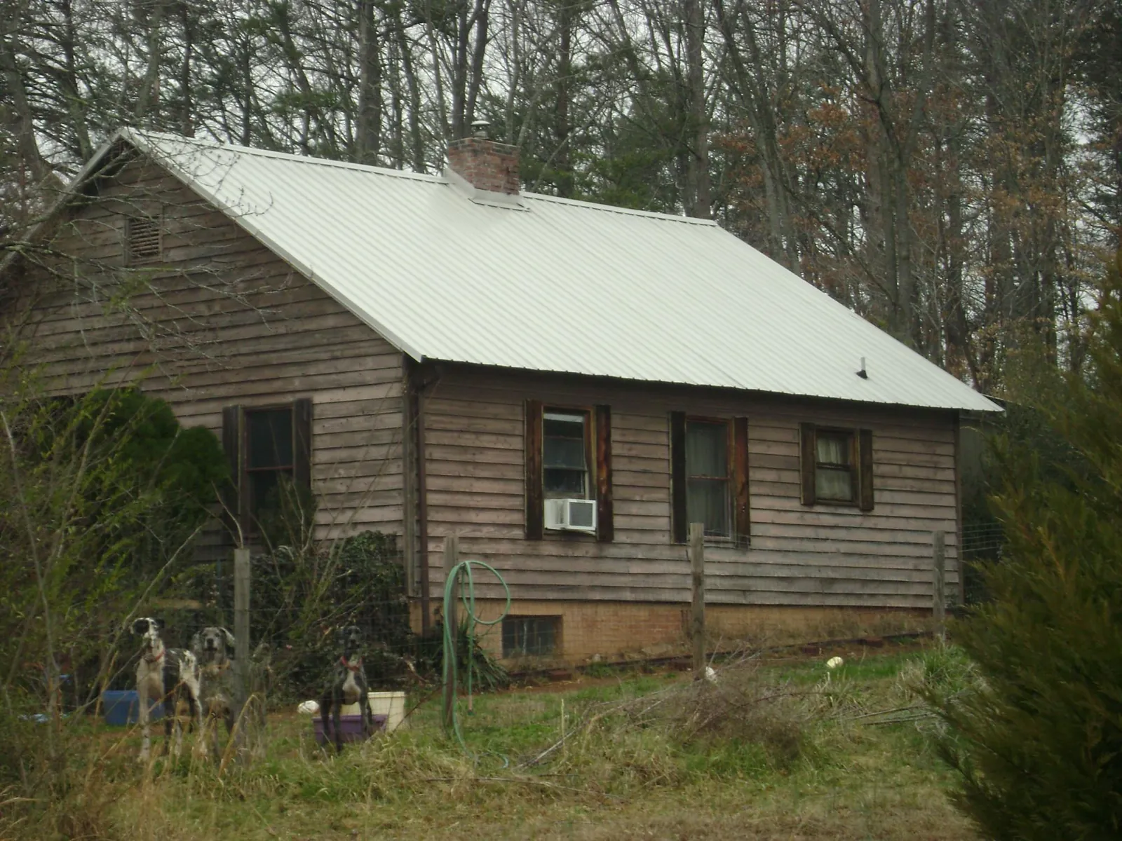 White metal roof on an old wood sided farmhouse, from a Metal Roof Installation job in Watchung
